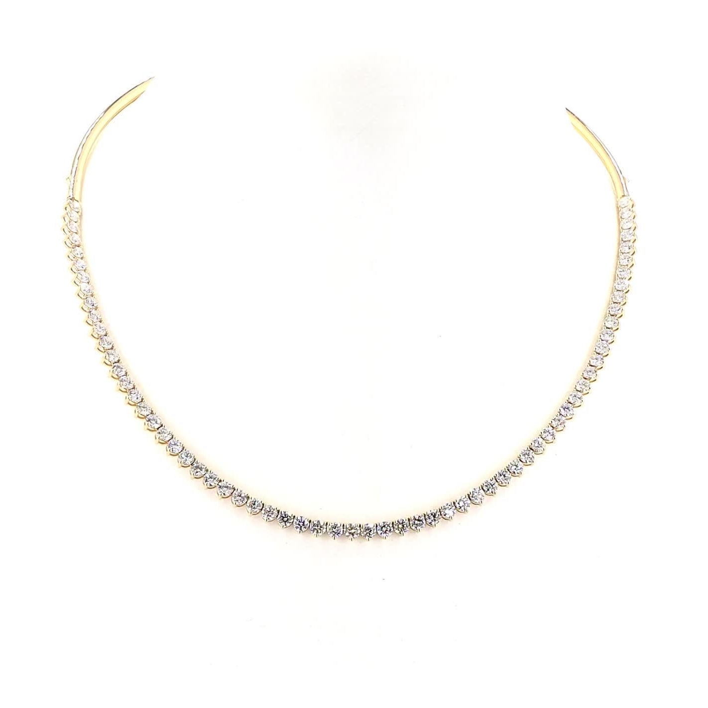Gold necklace with small diamonds on a white background