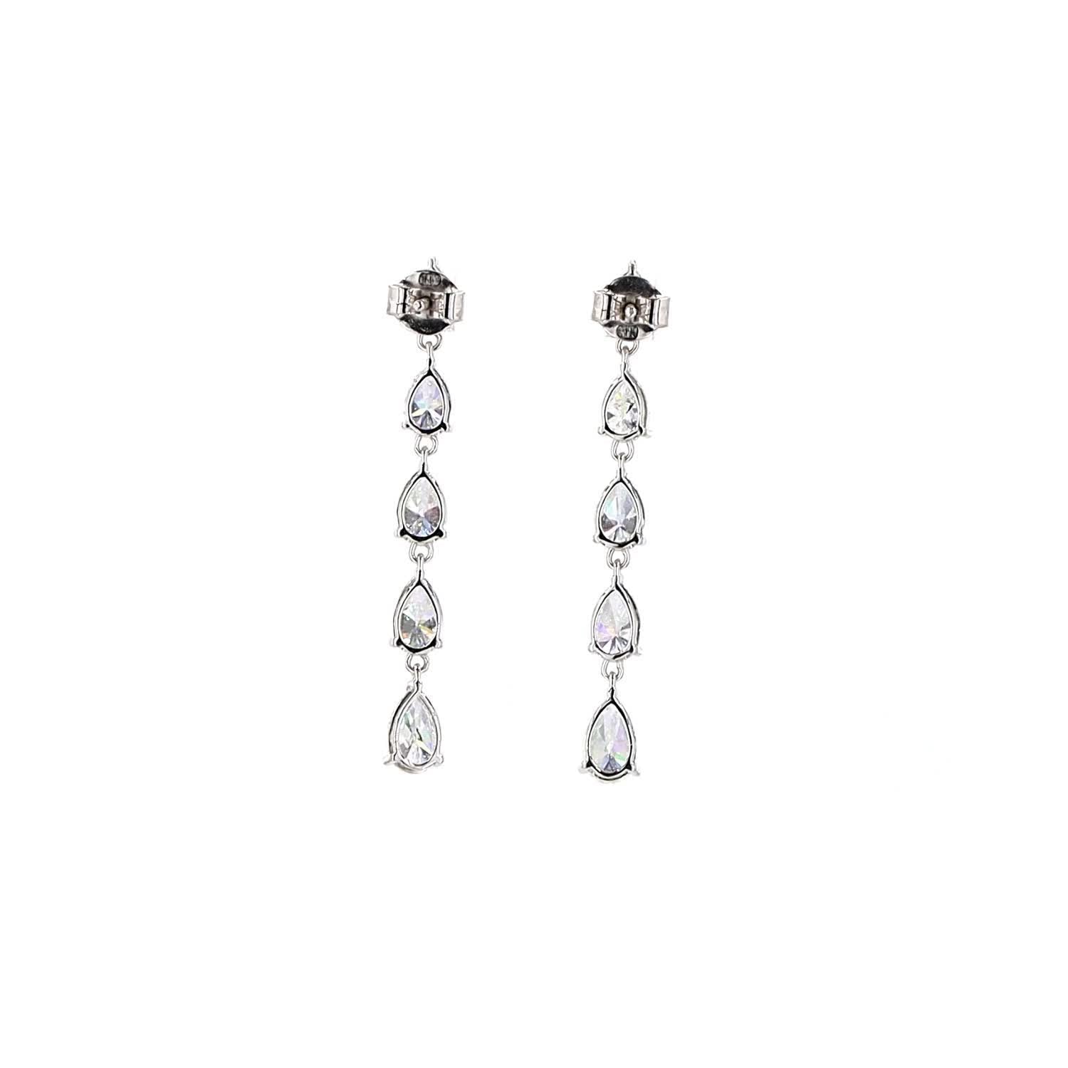 Pair of diamond drop earrings on a white background
