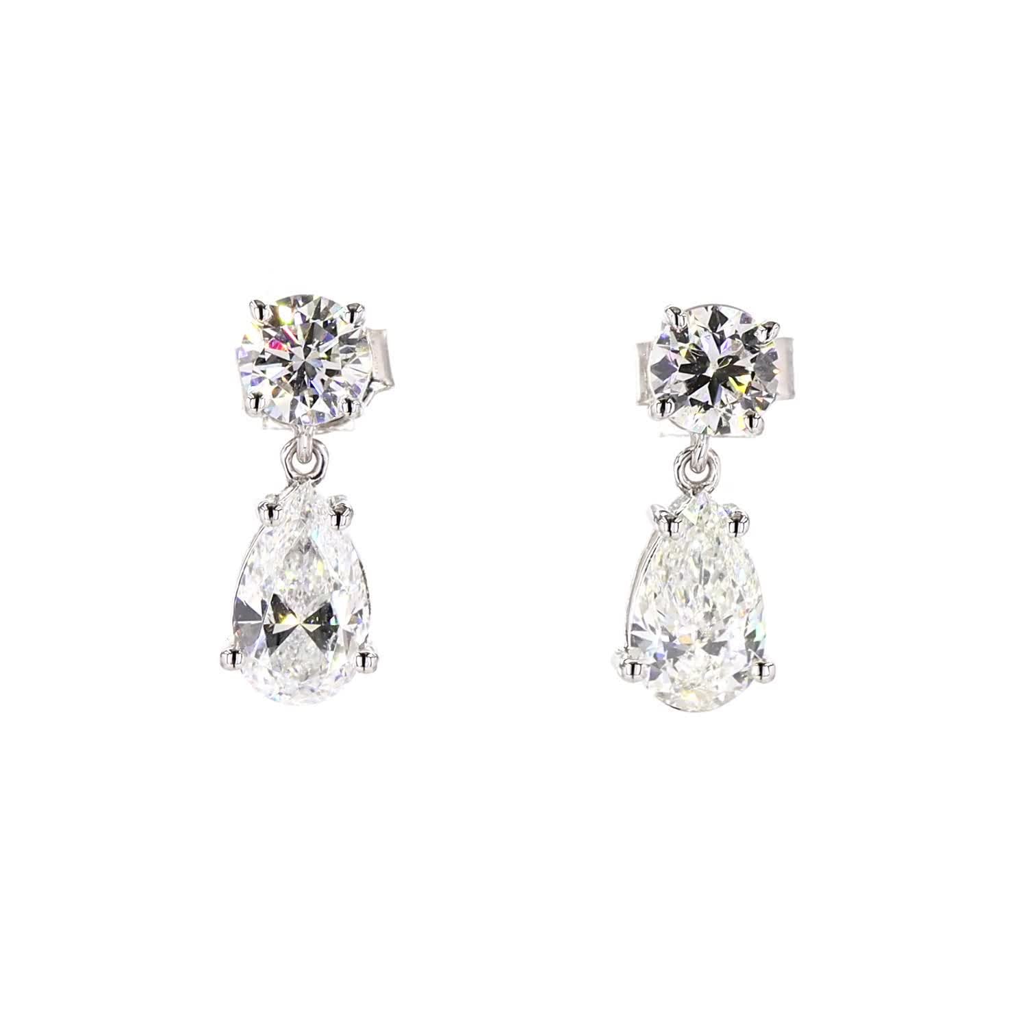 Pair of teardrop-shaped diamond earrings on a white background